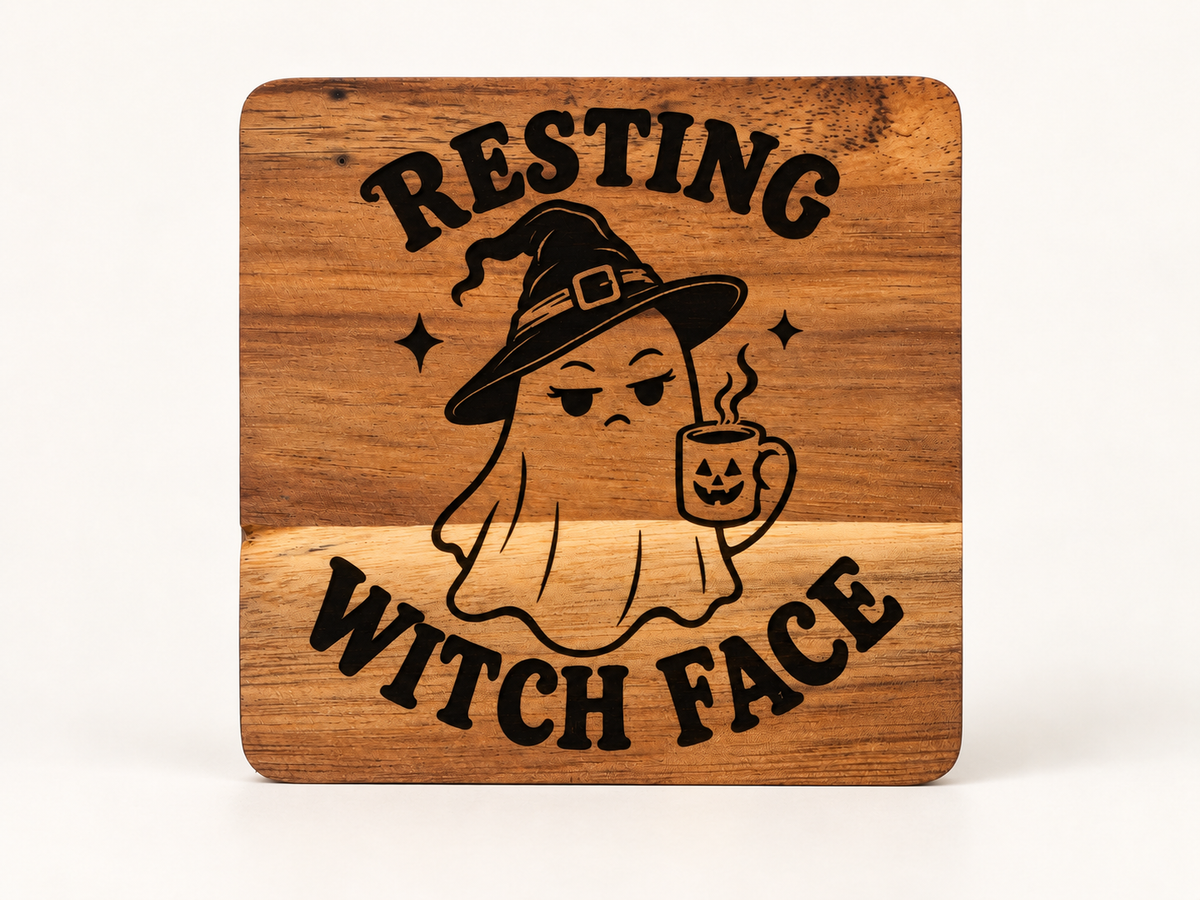 Actual Resting Witch Face engraved wood coaster, upright on a clean background