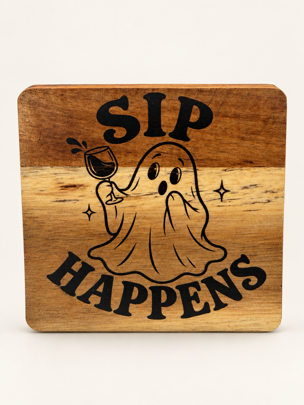 Actual Sip Happens engraved wood coaster on a clean background